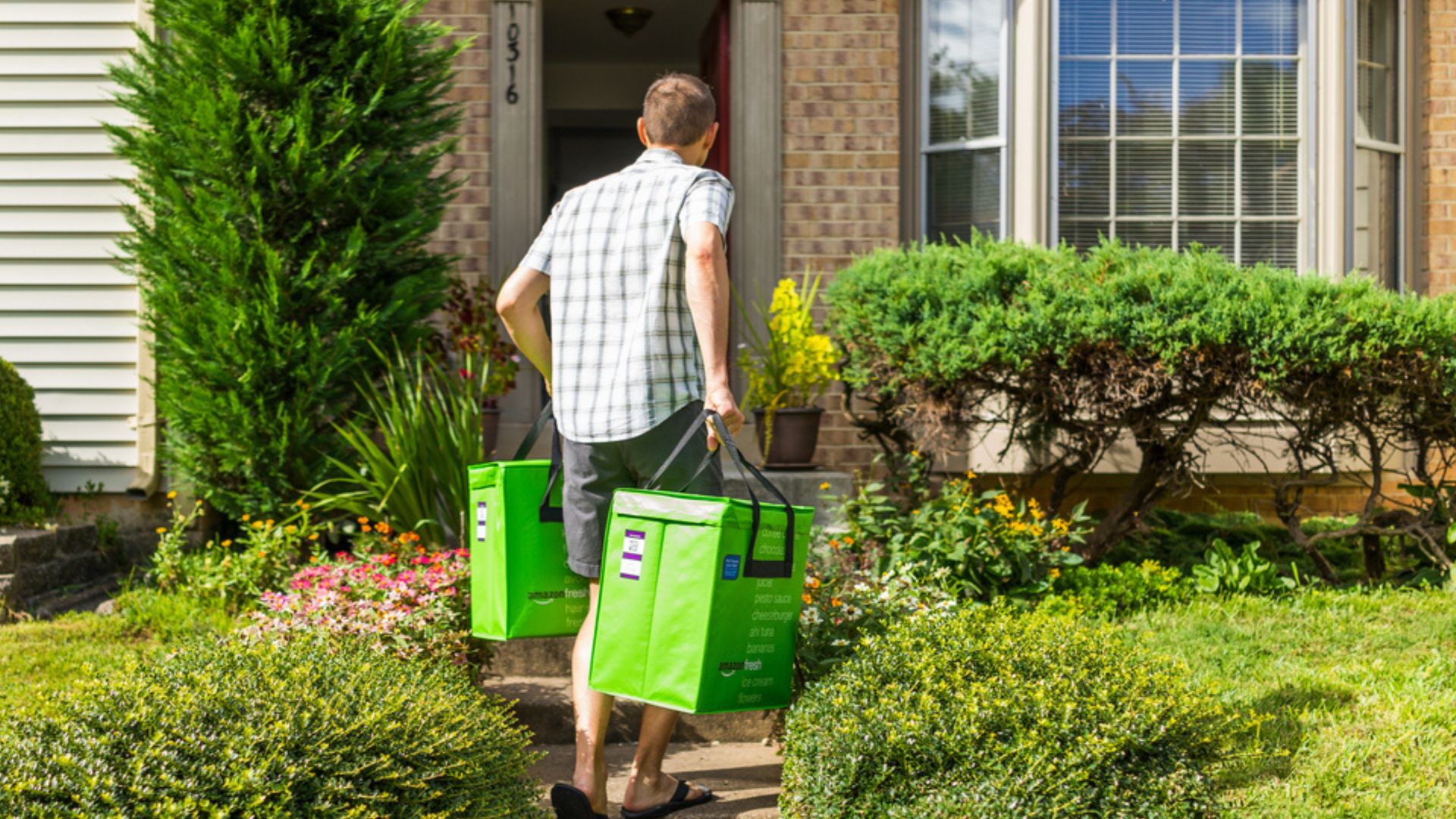 image showing an Amazon Fresh driver delivering groceries to a front door of a house - to illustrate amazon fresh tip best practices